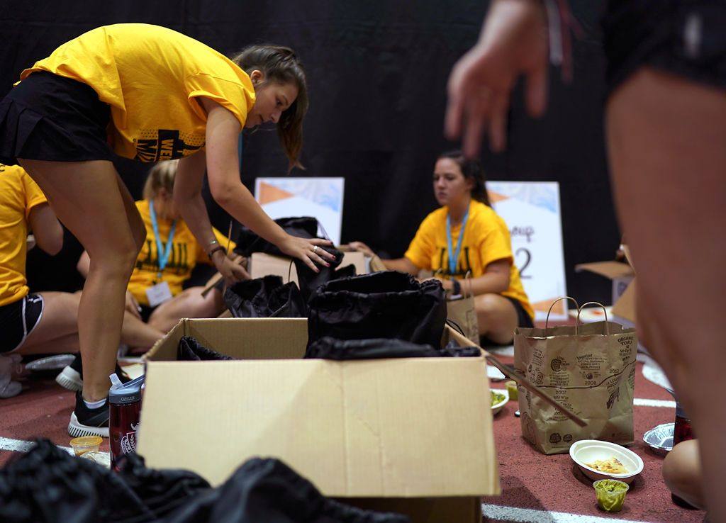 Zoe Bowman, left, sorts through backpacks